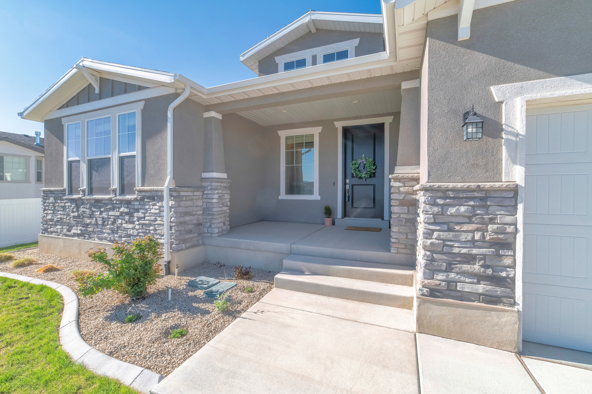 Front exterior of a house with nice front yard and garage